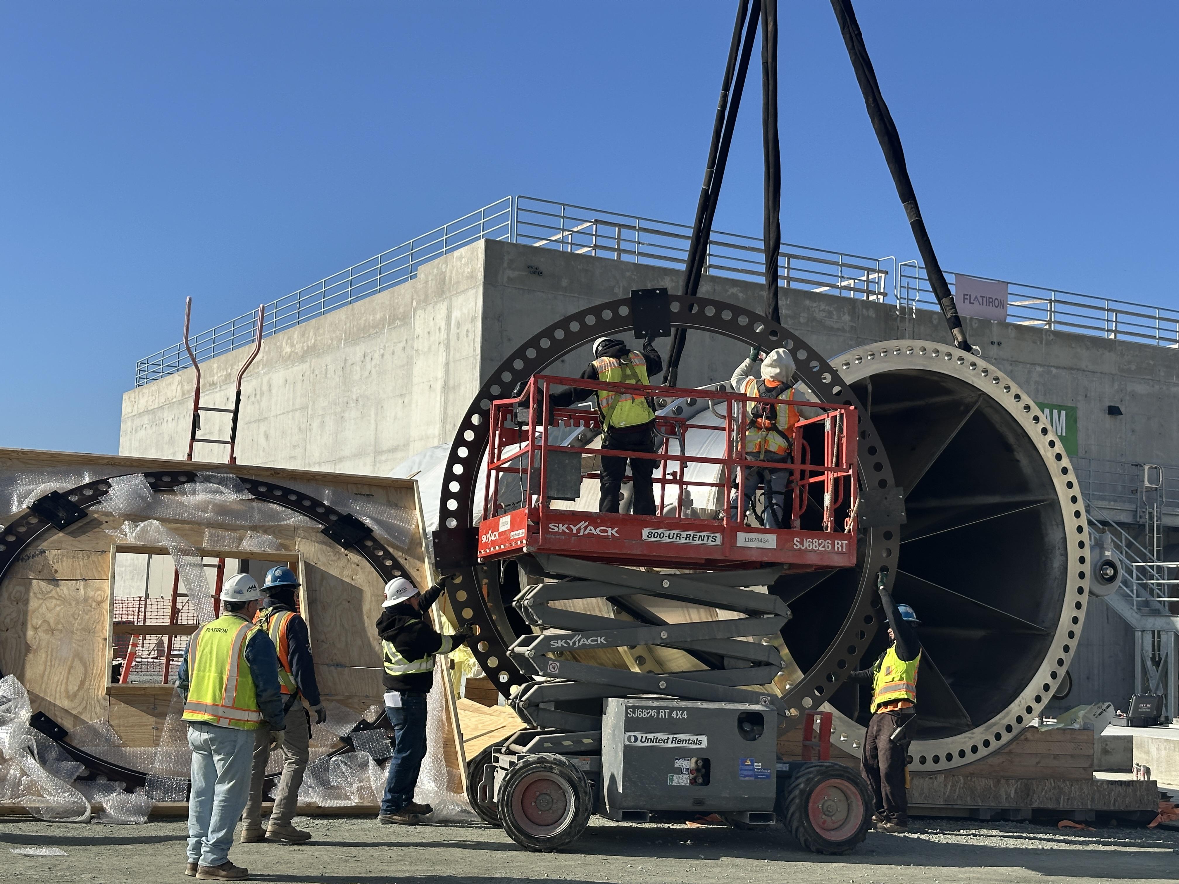 The Anderson Dam Tunnel Project contractor installs one of two 11-foot-diameter fixed-cone valves in the diversion outlet structure. Water from the reservoir will be released through these large-diameter valves during diversion operations.