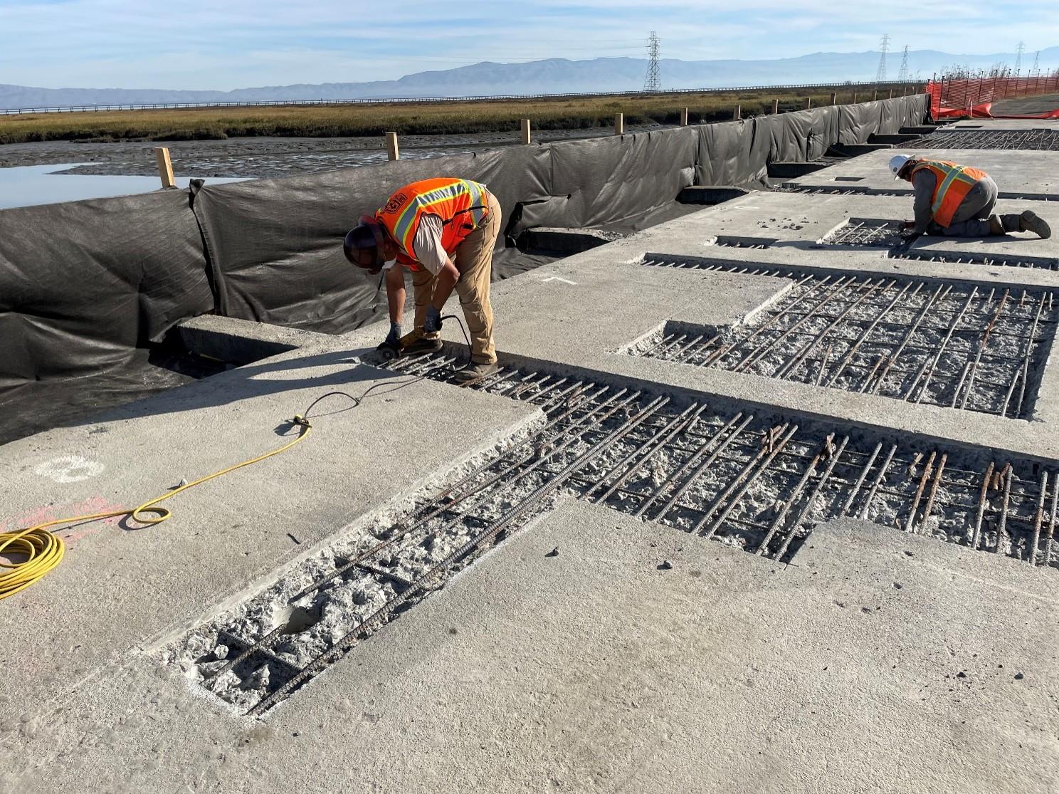 Workers repaired damaged reinforced concrete and resurfaced the structure's top with polyester polymer concrete.