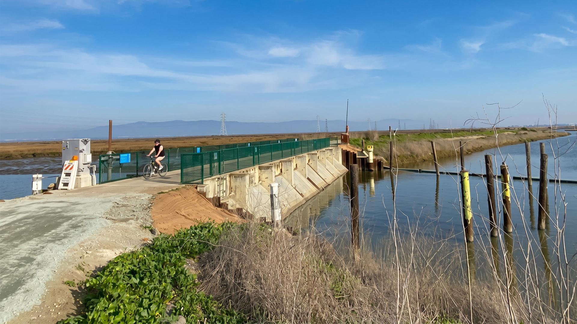 The tide gate structure has been seismically retrofitted and rehabilitated, featuring deeper foundations to withstand extreme seismic events, new barrier fencing, and a newly resurfaced top.