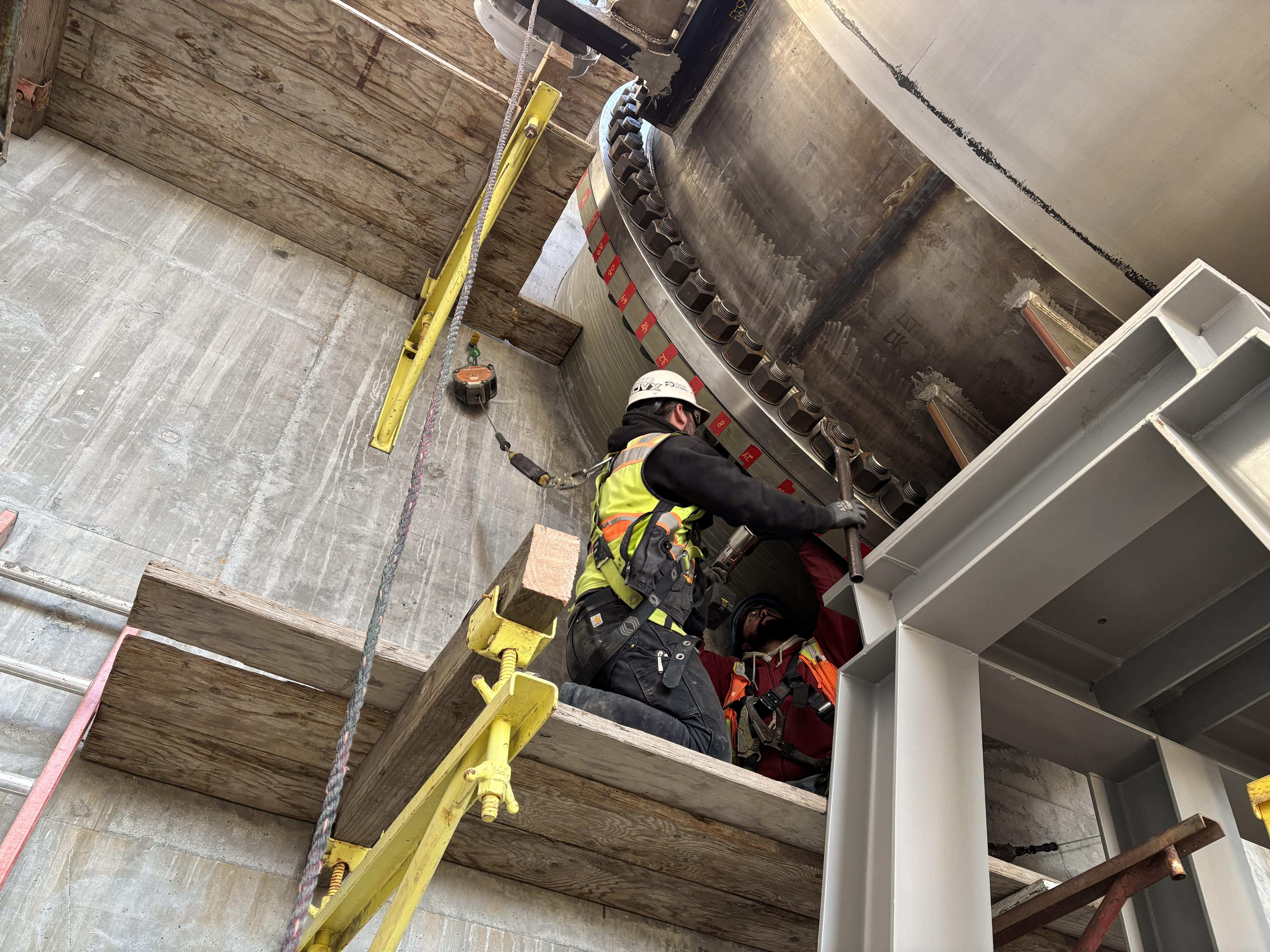 Construction crew torques bolts to secure one of two 11-foot-diameter fixed-cone valves, which will release water to Coyote Creek to dewater Anderson Reservoir during construction of the upcoming Anderson Dam Seismic Retrofit Project. 