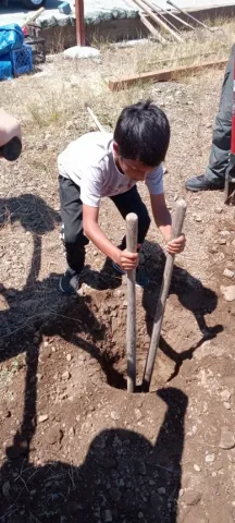 Scout digs the hole for the post.